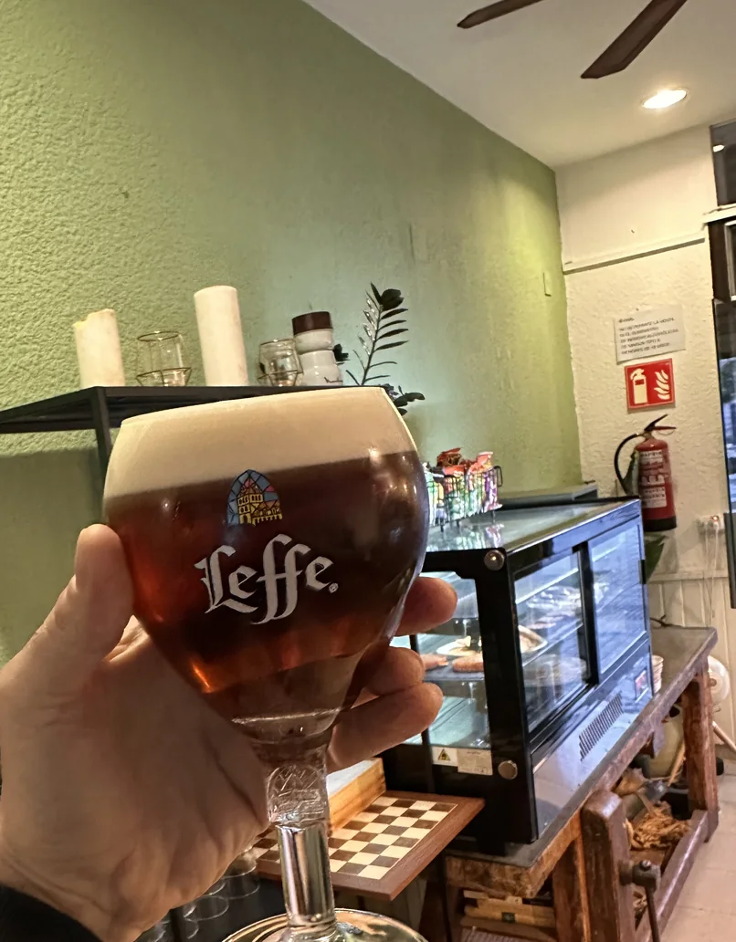 Glass of beer served beside the green Le Bistrot bar