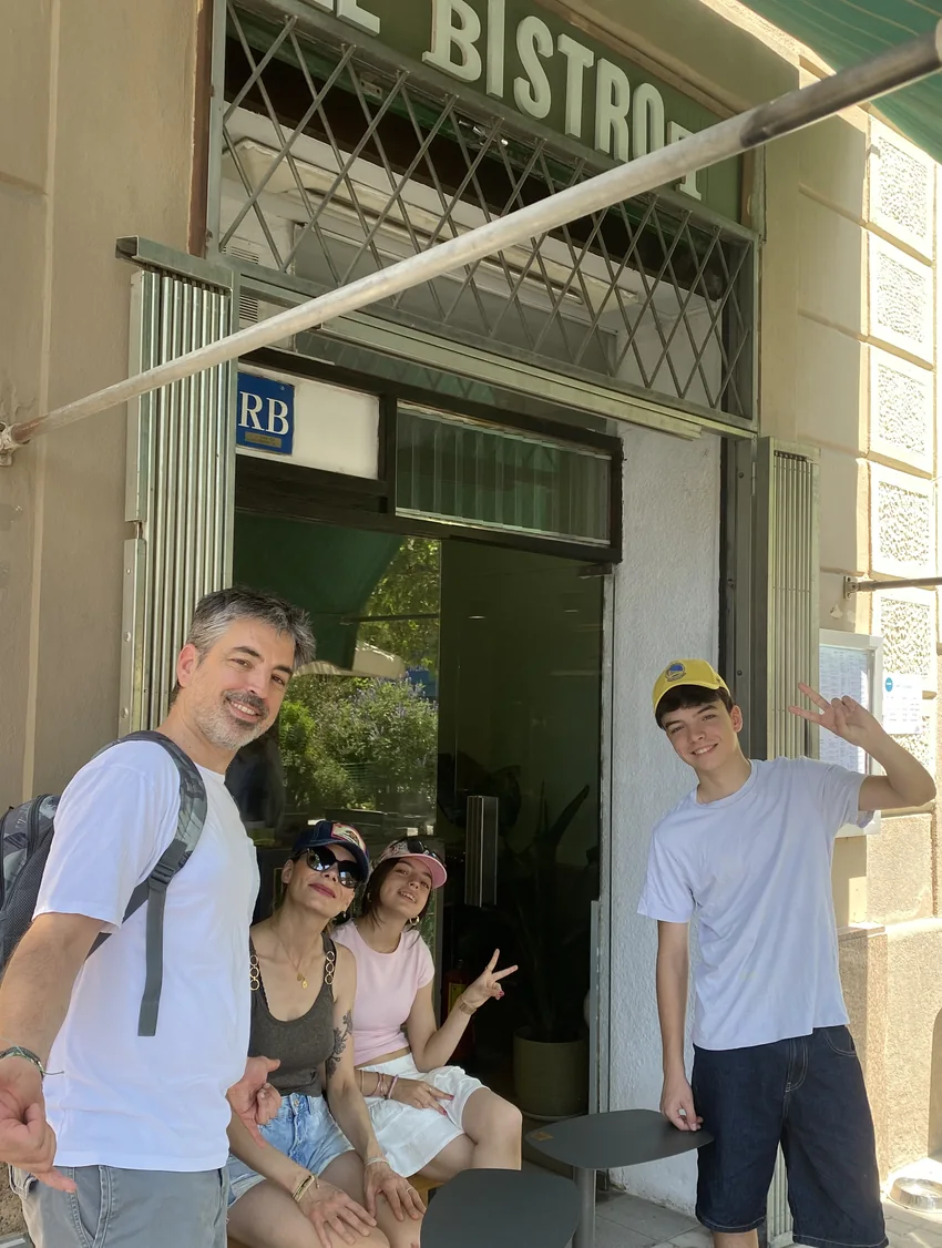 Guests at the Le Bistrot door under the sign